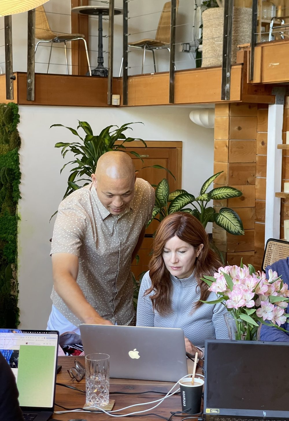 Tim Park coaching a professional through an AI build on her laptop